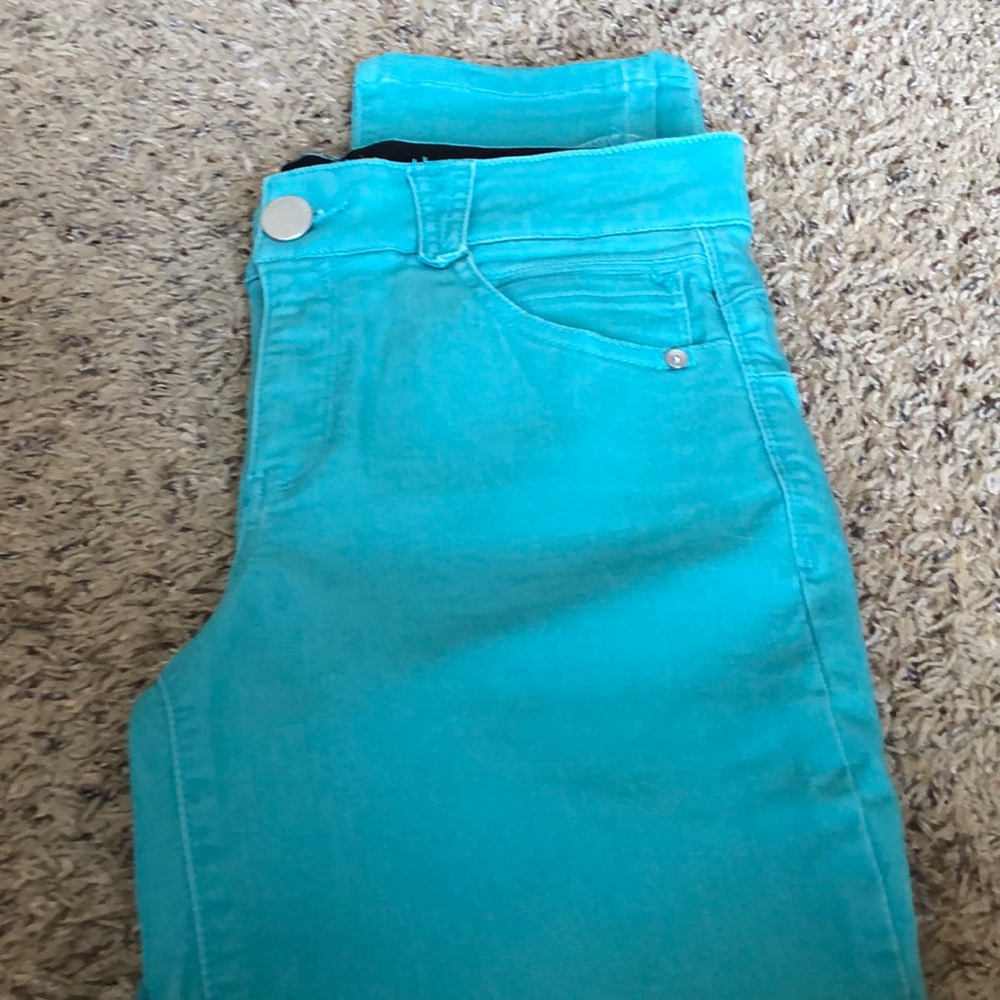 Turquoise Democracy ankle jeans.